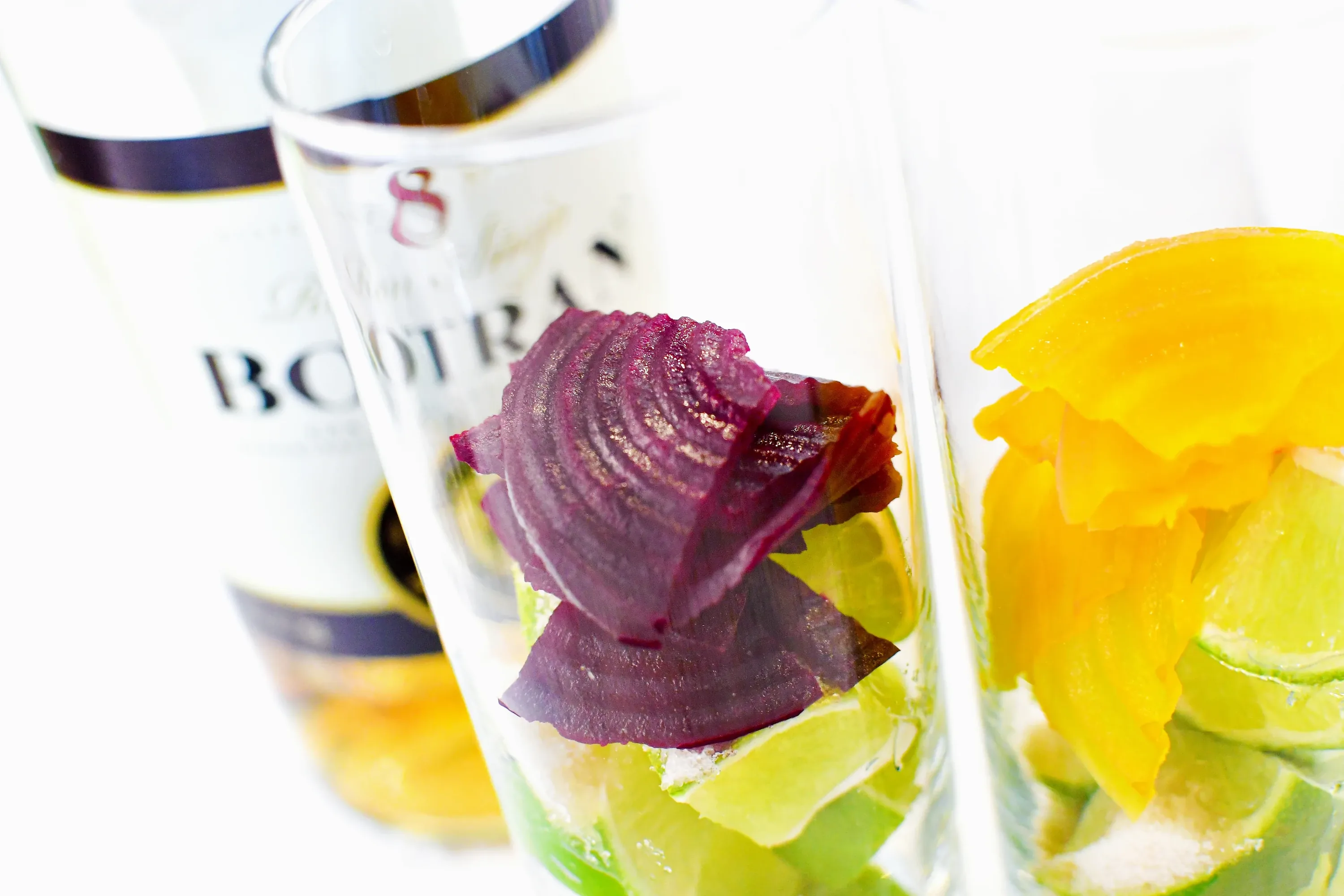 Red beet and lime prepared in a highball glass for a Beet Mojito