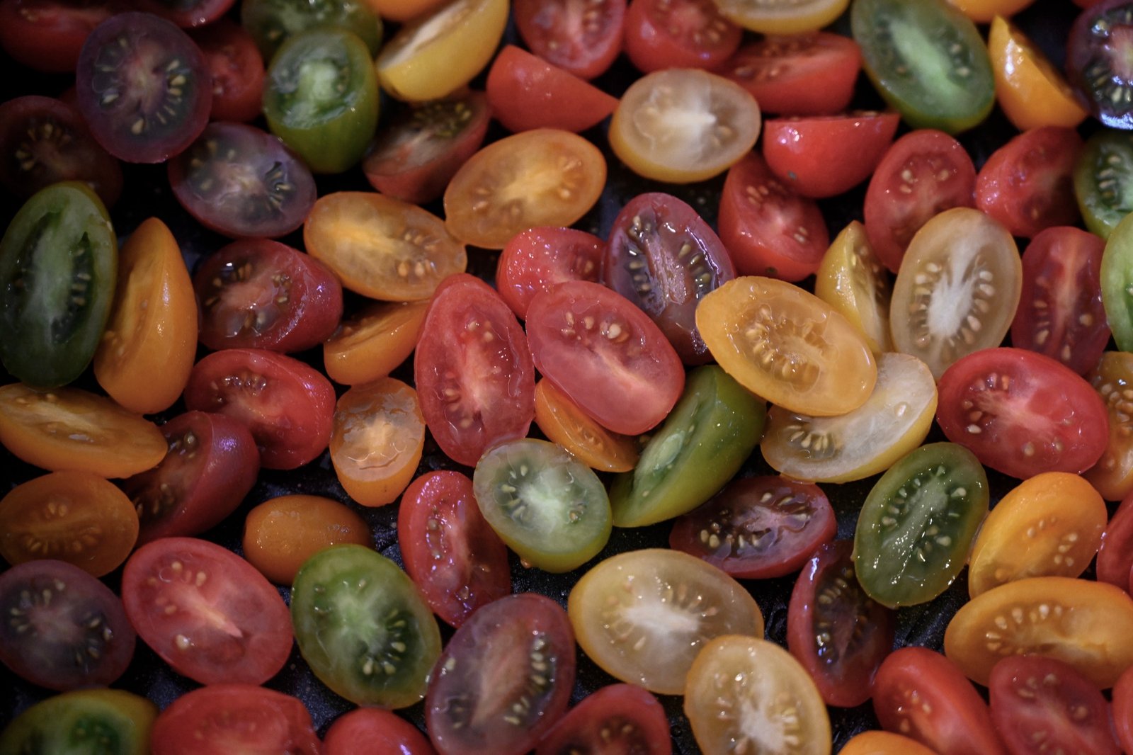 Colorful mixed cherry tomatoes halved and ready for slow roasting